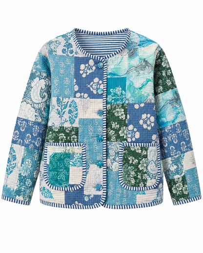 A long-sleeve quilted patchwork jacket featuring a blue, teal, and green floral and paisley print, with striped trim on the collar, cuffs, and pocket edges.