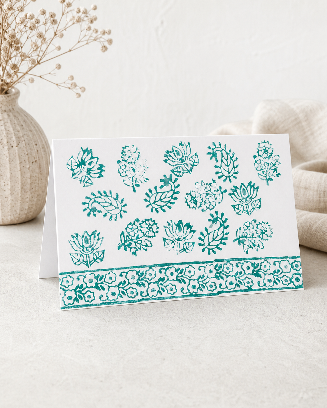 Card with green floral patterns on a white background