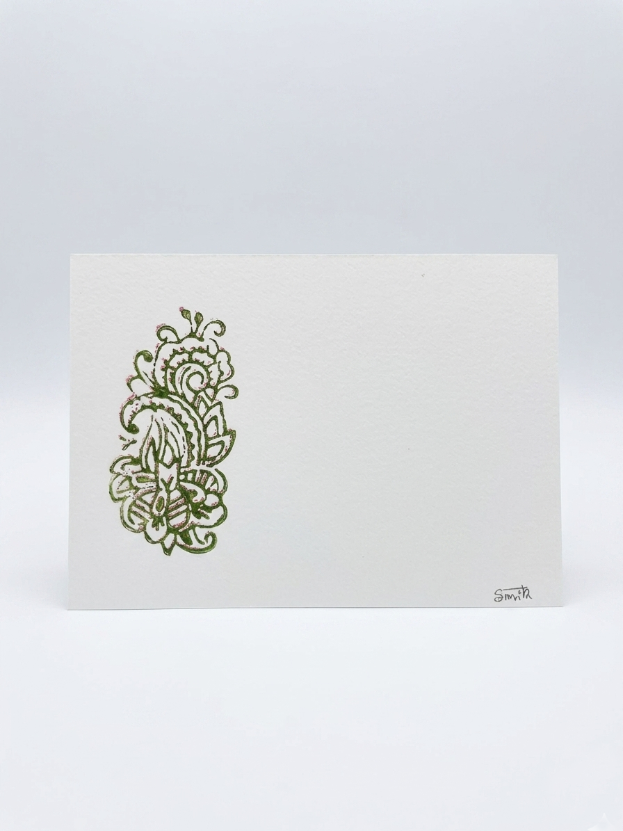 White card with green floral design on a light gray background