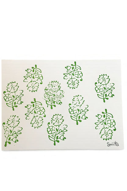White paper with green floral patterns and 'amita' branding on a white background