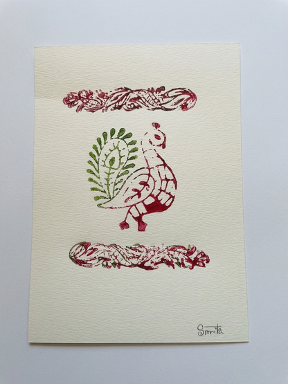 Decorative card with a red and green design of a bird and leaves on a beige background